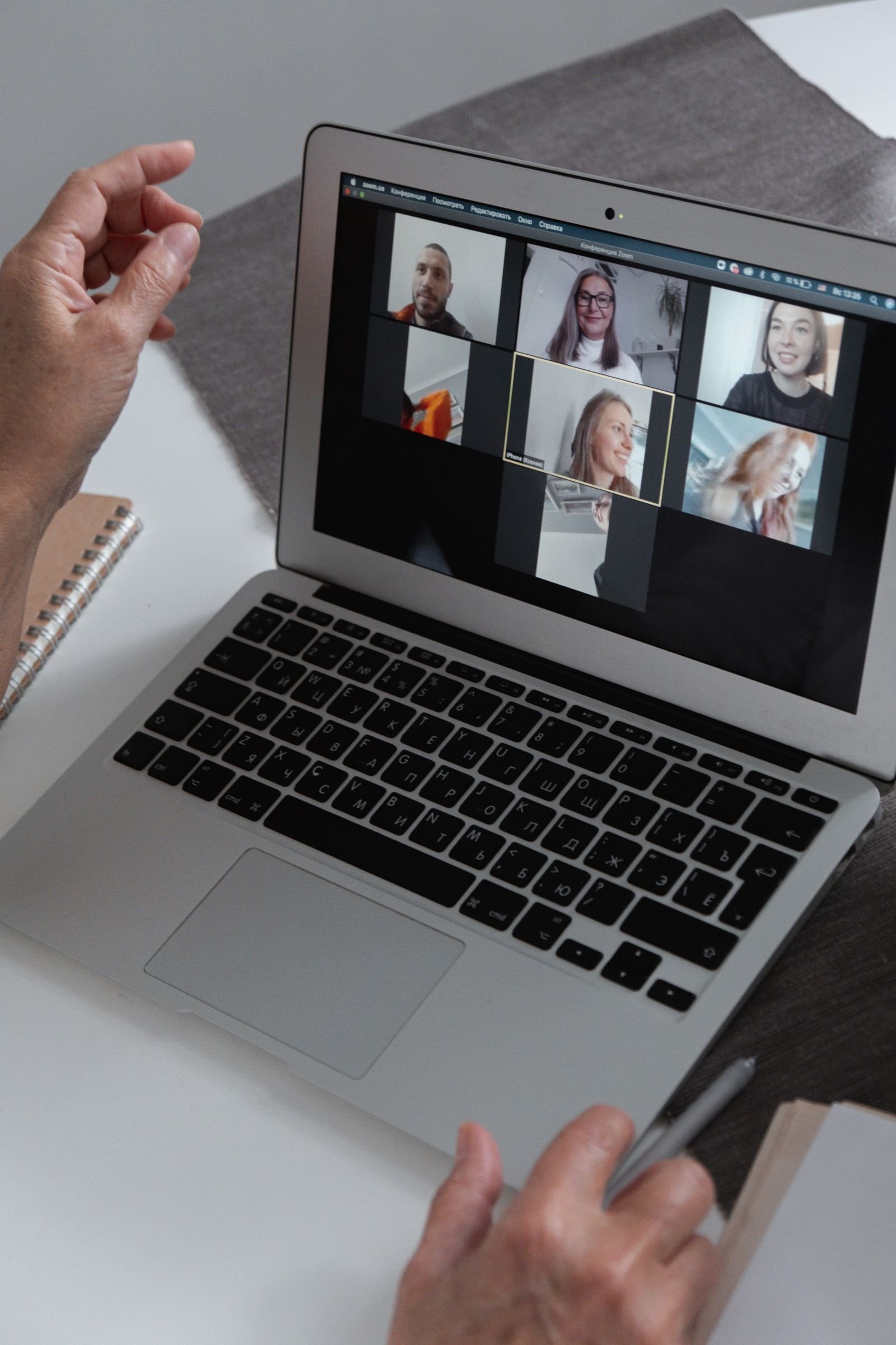 Laptop screen showing a group video call panel discussion